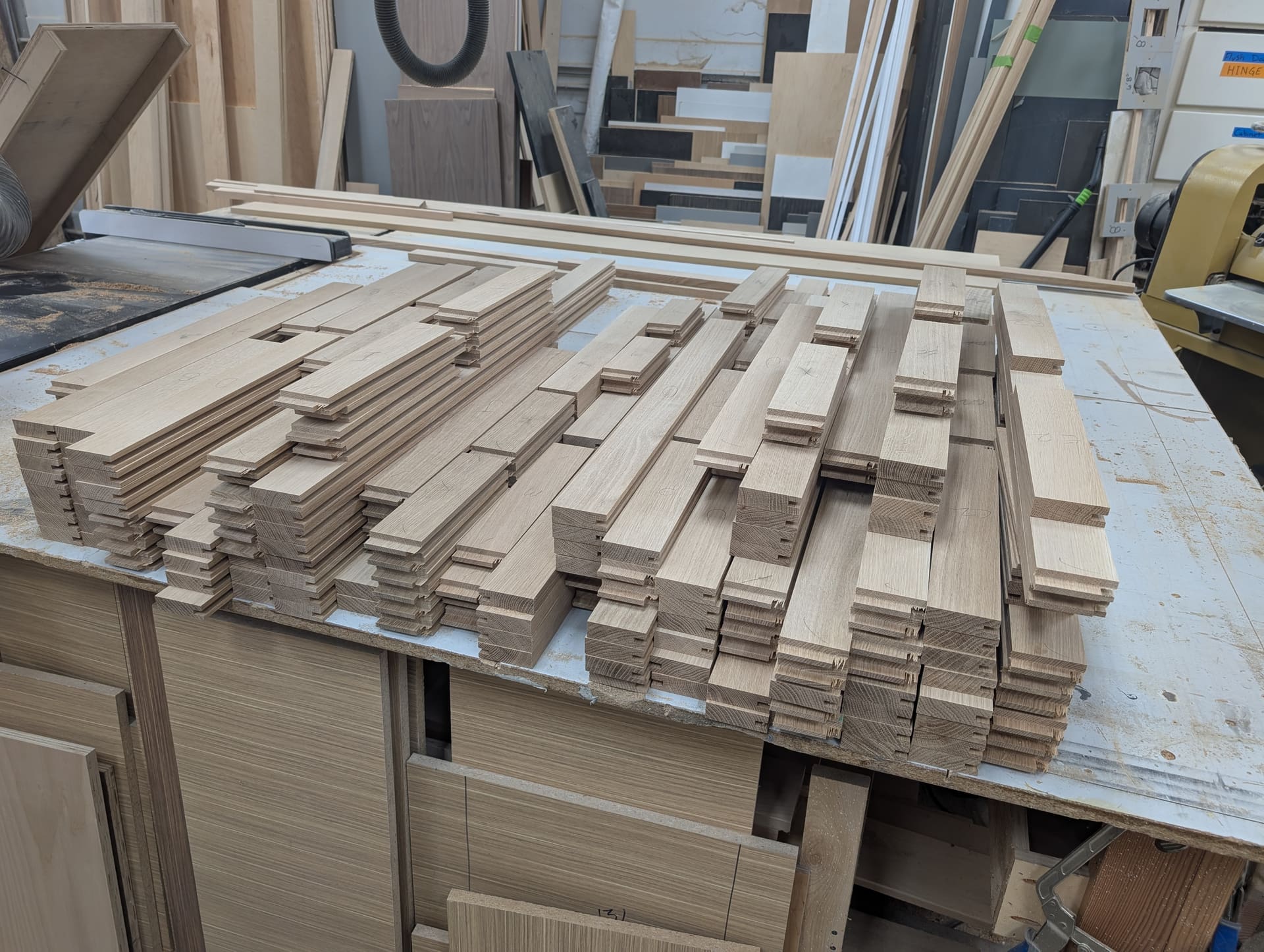 Cabinet face frame components staged in the shop before assembly
