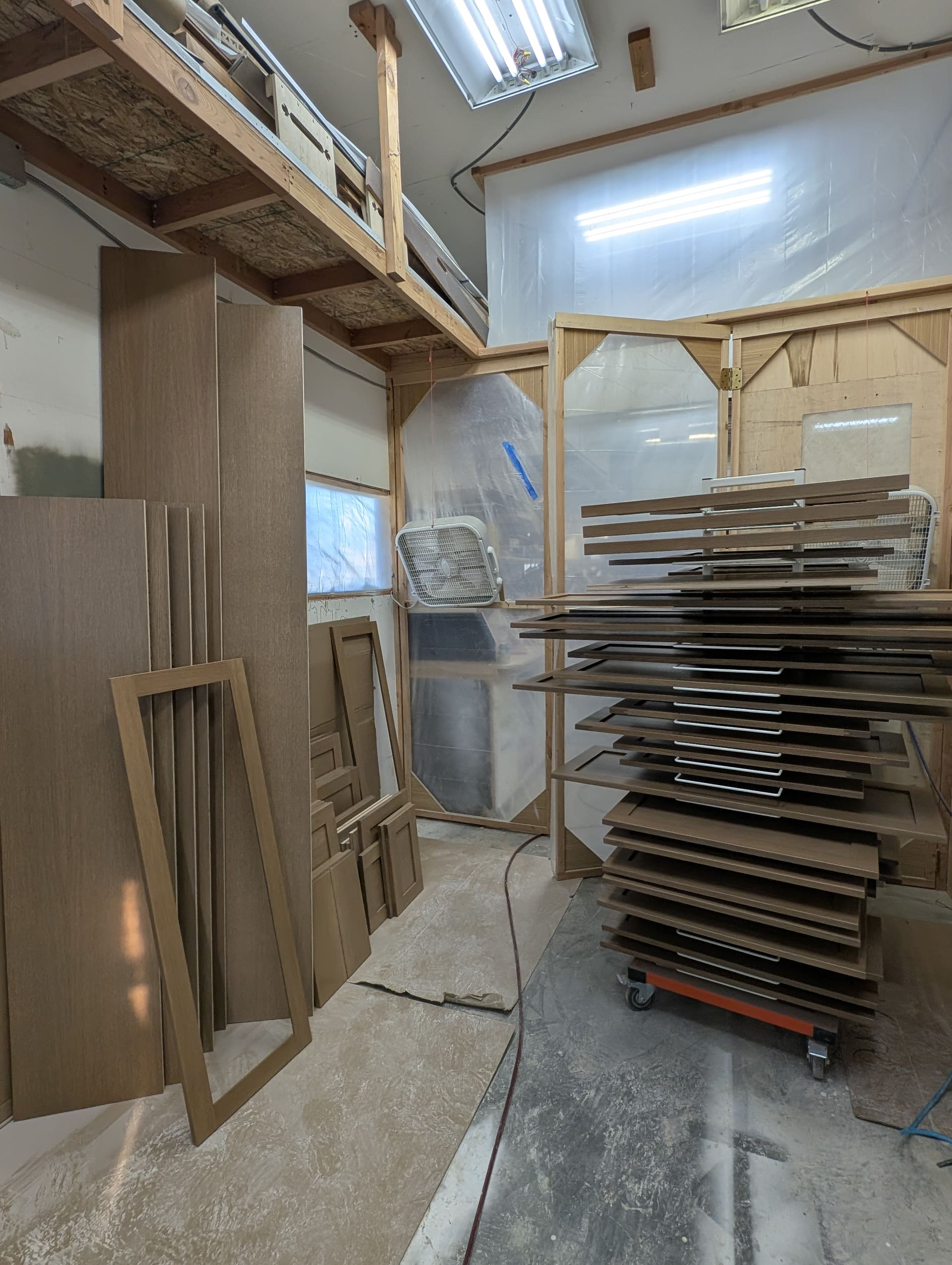 Cabinet doors on a drying rack in the finishing spray booth
