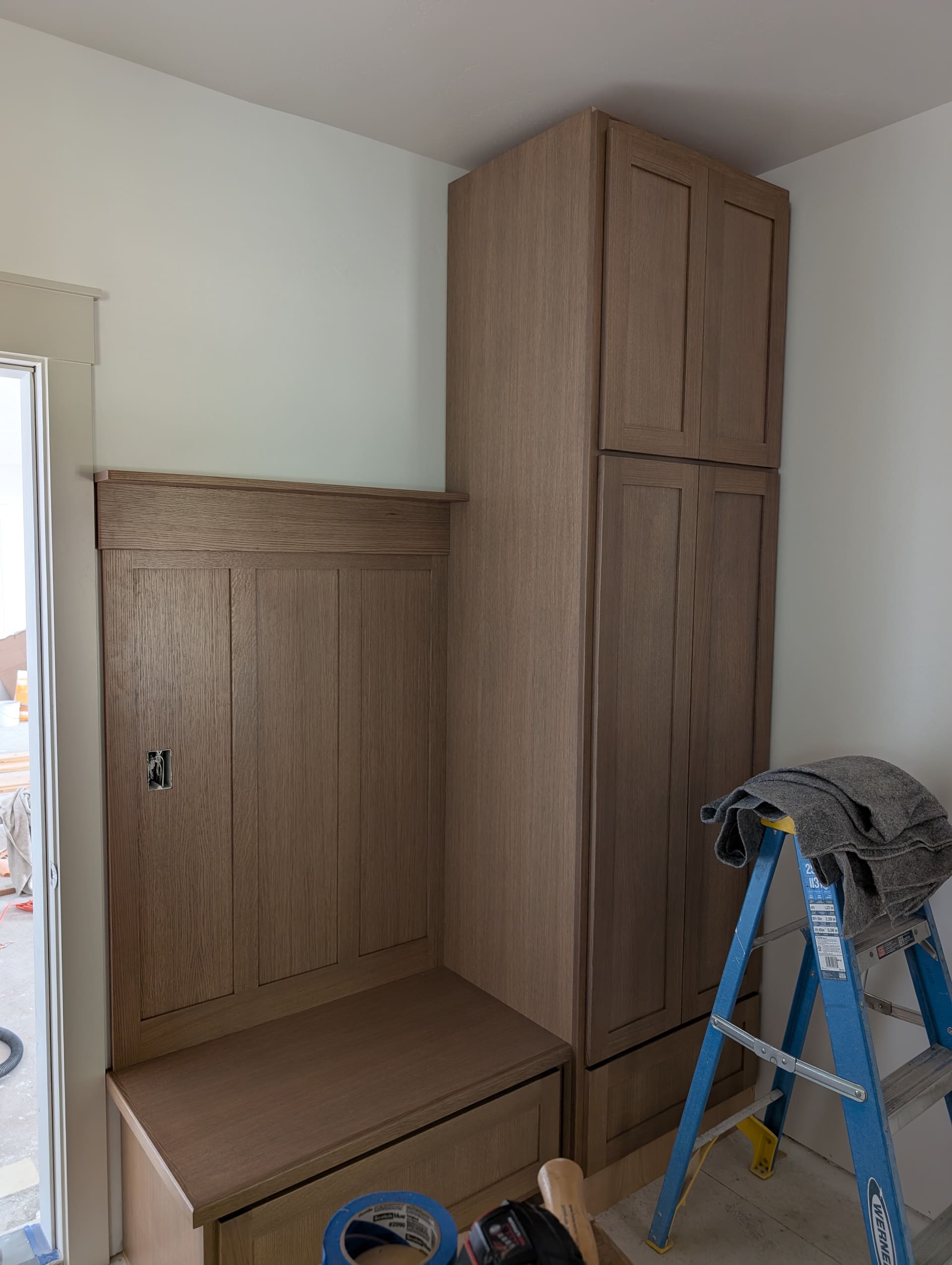 Custom mudroom locker and bench with built-in pantry tower