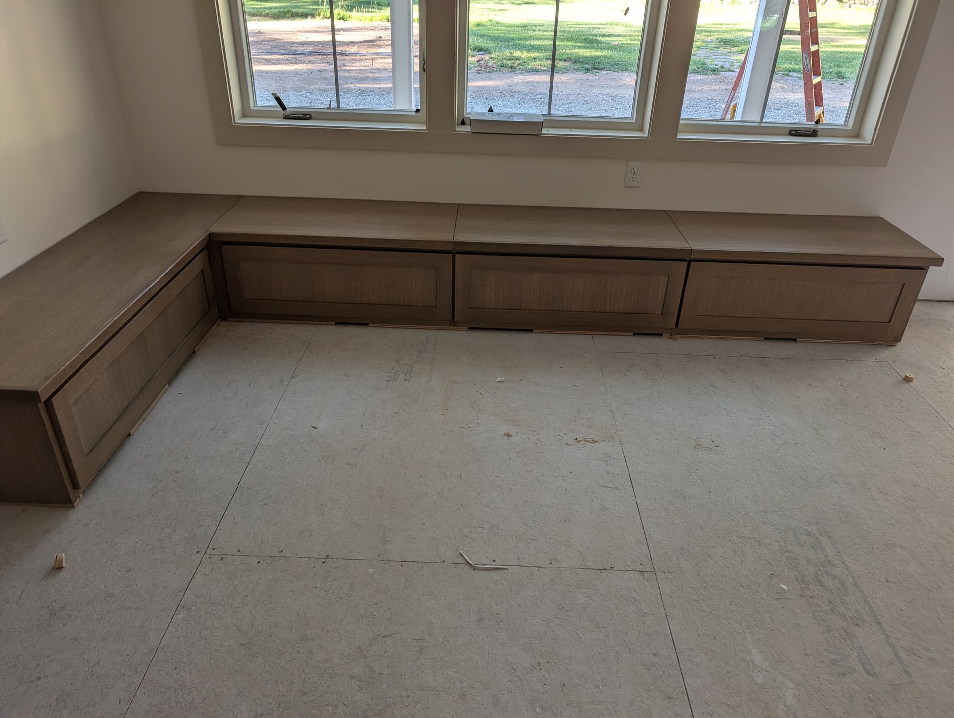 Custom built-in window seat with storage drawers below