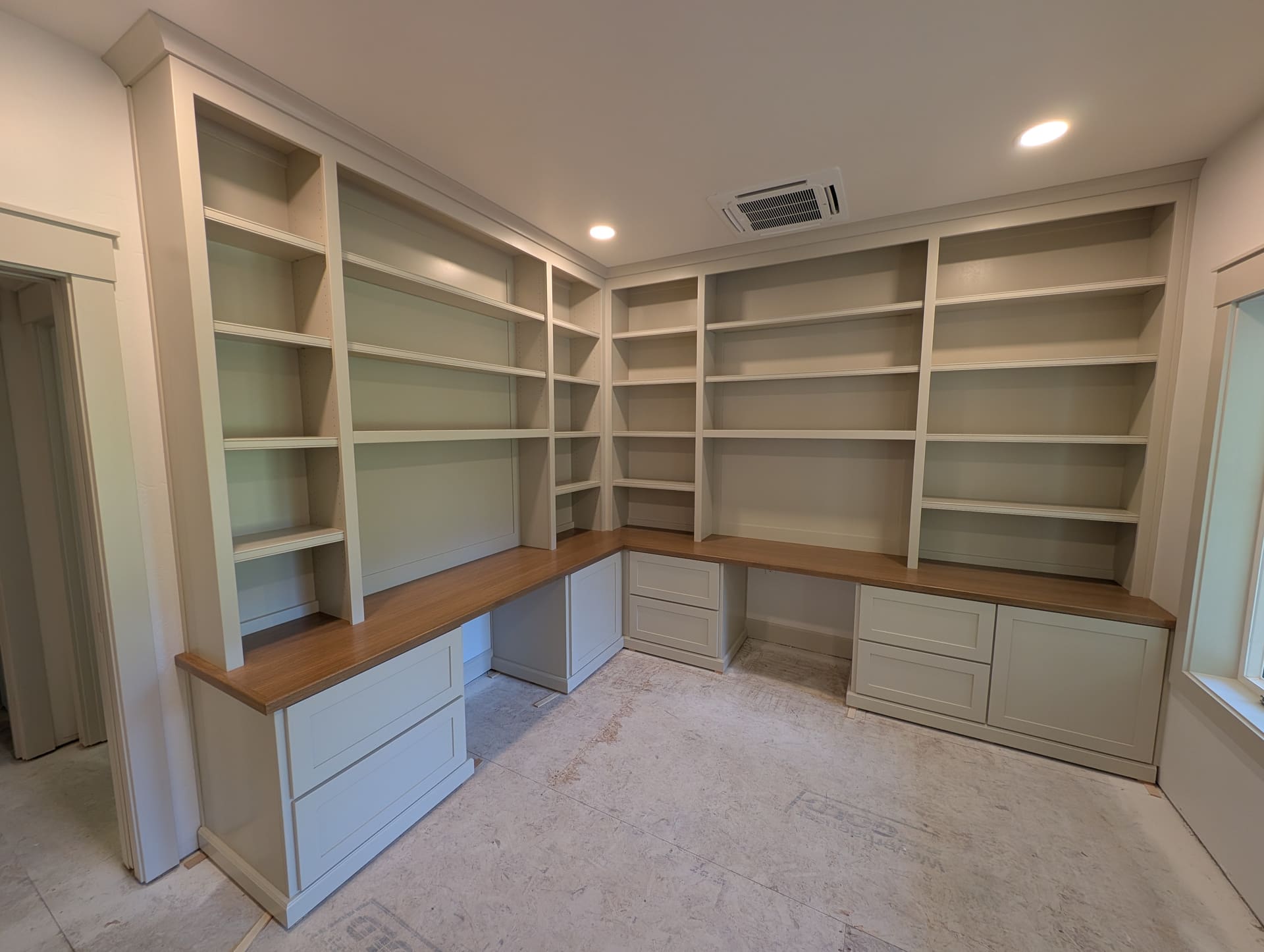 Floor-to-ceiling custom built-in with bookshelves and a built-in desk