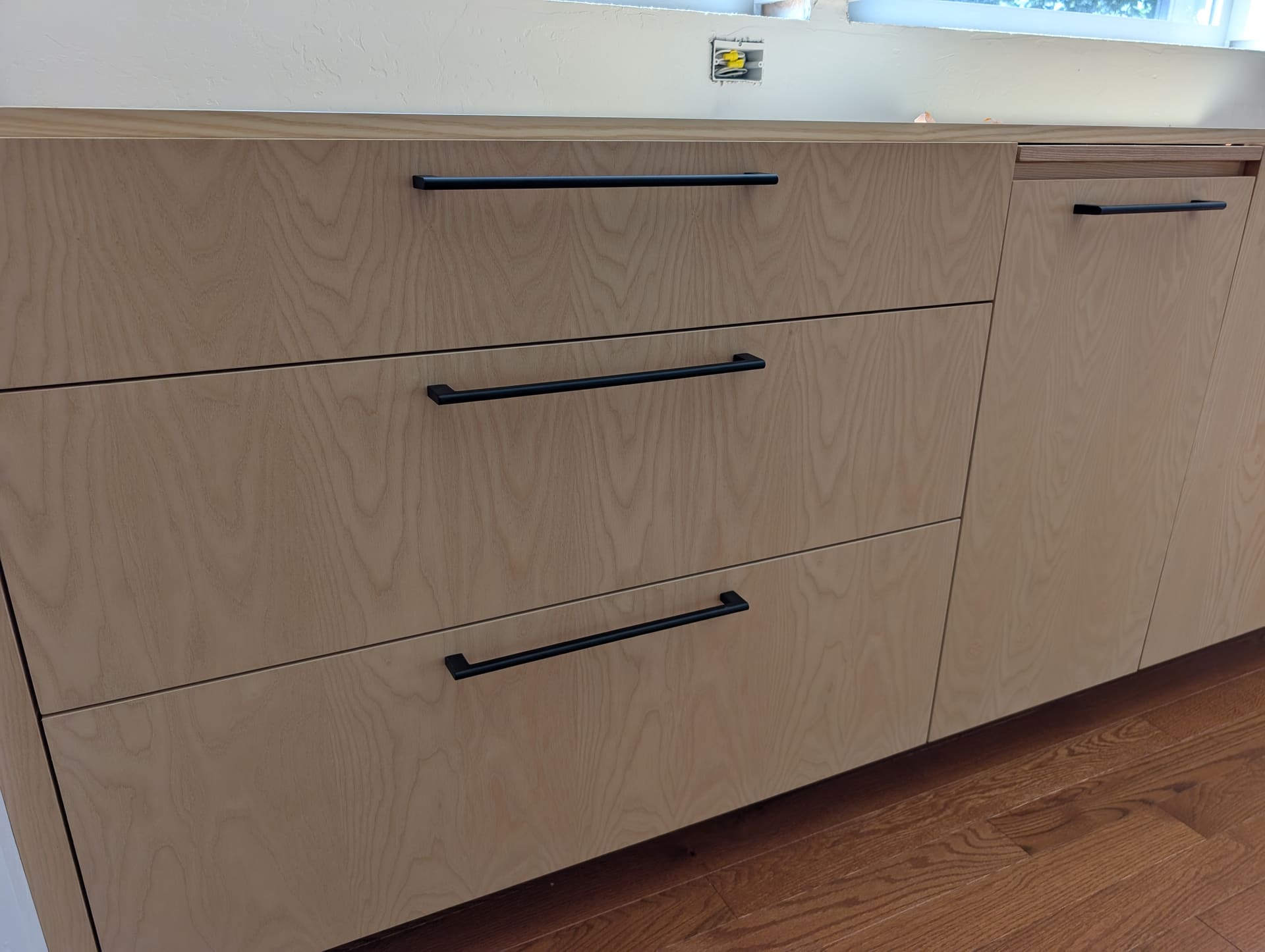 Detail of soft-close drawer fronts with matte black bar pulls